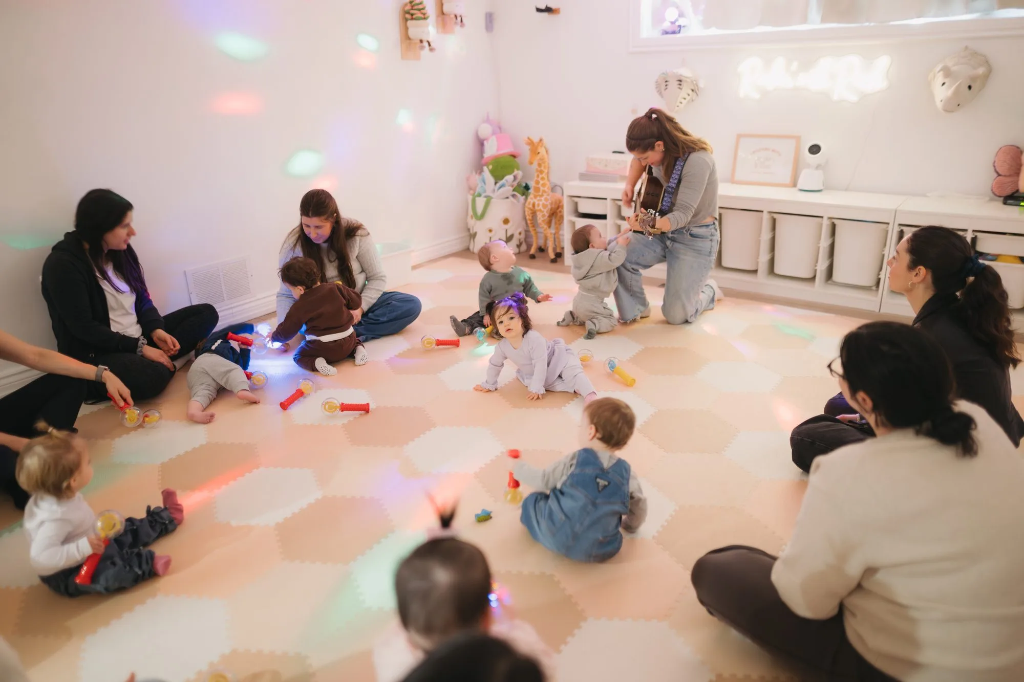Babies and caregivers in a circle at Rockin' with Rach baby music class Toronto