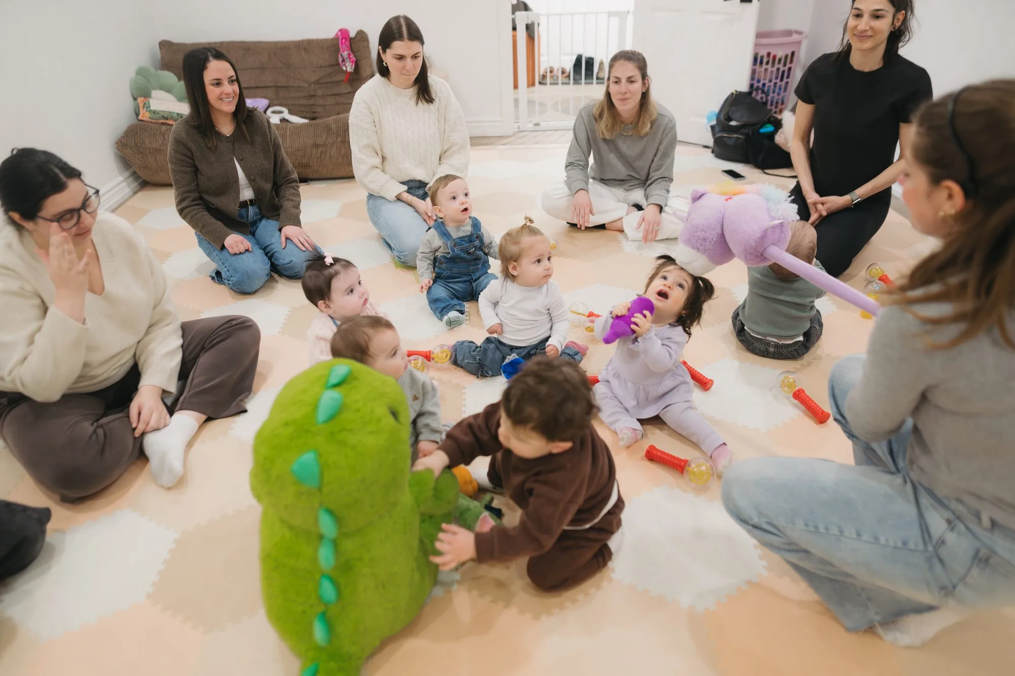 Babies playing with puppets and instruments at a Rockin' with Rach class Toronto
