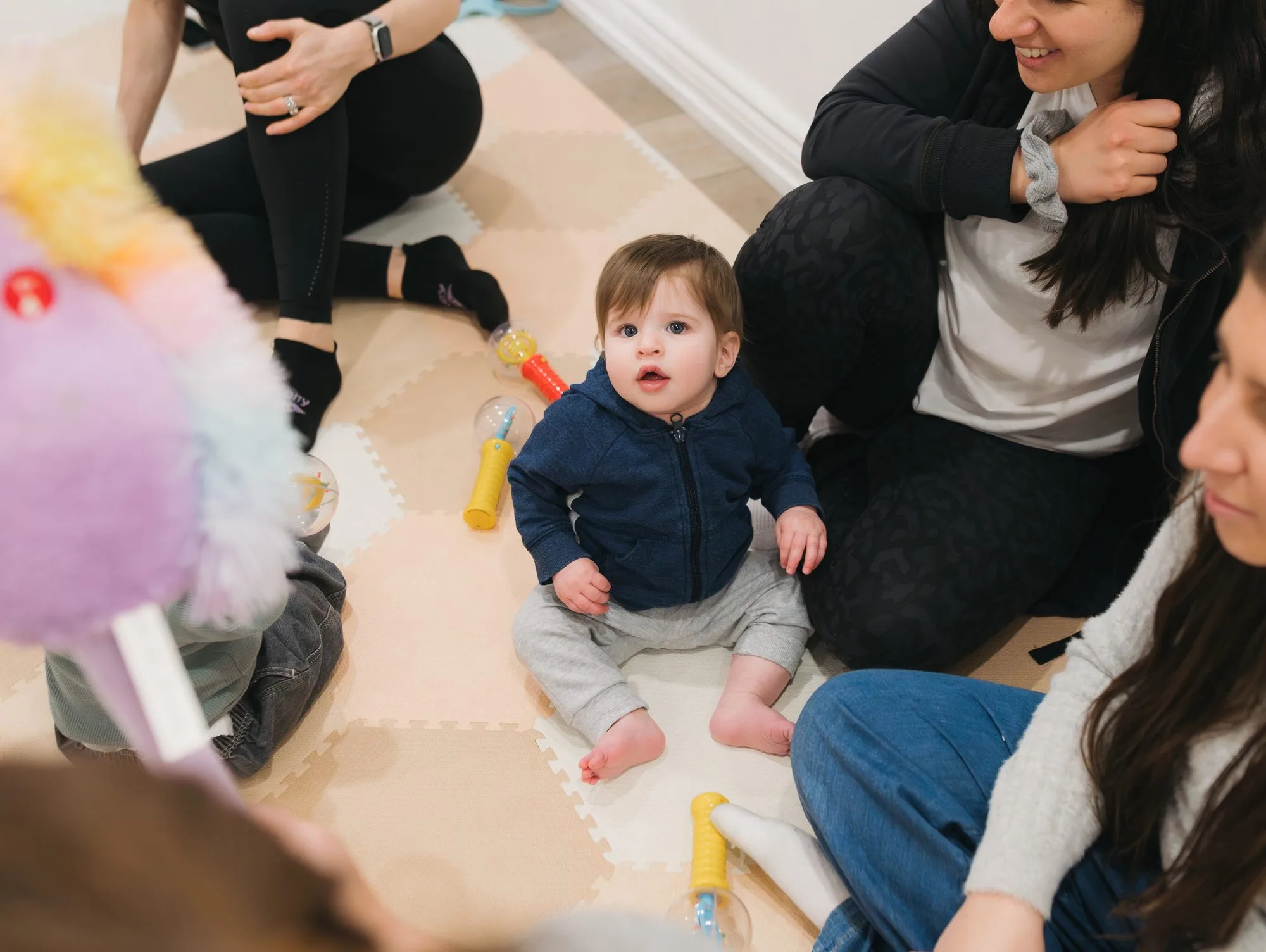 Baby boy in a blue hoodie looking curious in the Rockin' with Rach studio Toronto