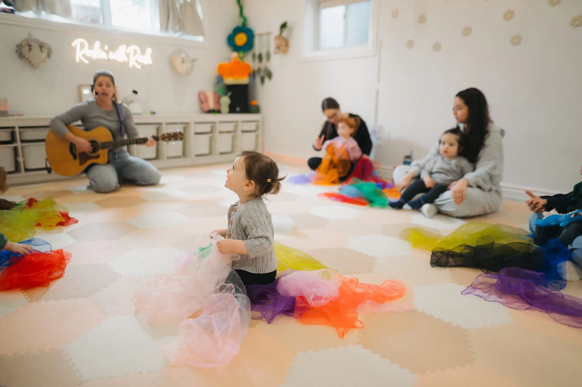 Baby music class with rainbow scarves at the Rockin' with Rach studio, serving Midtown Toronto families