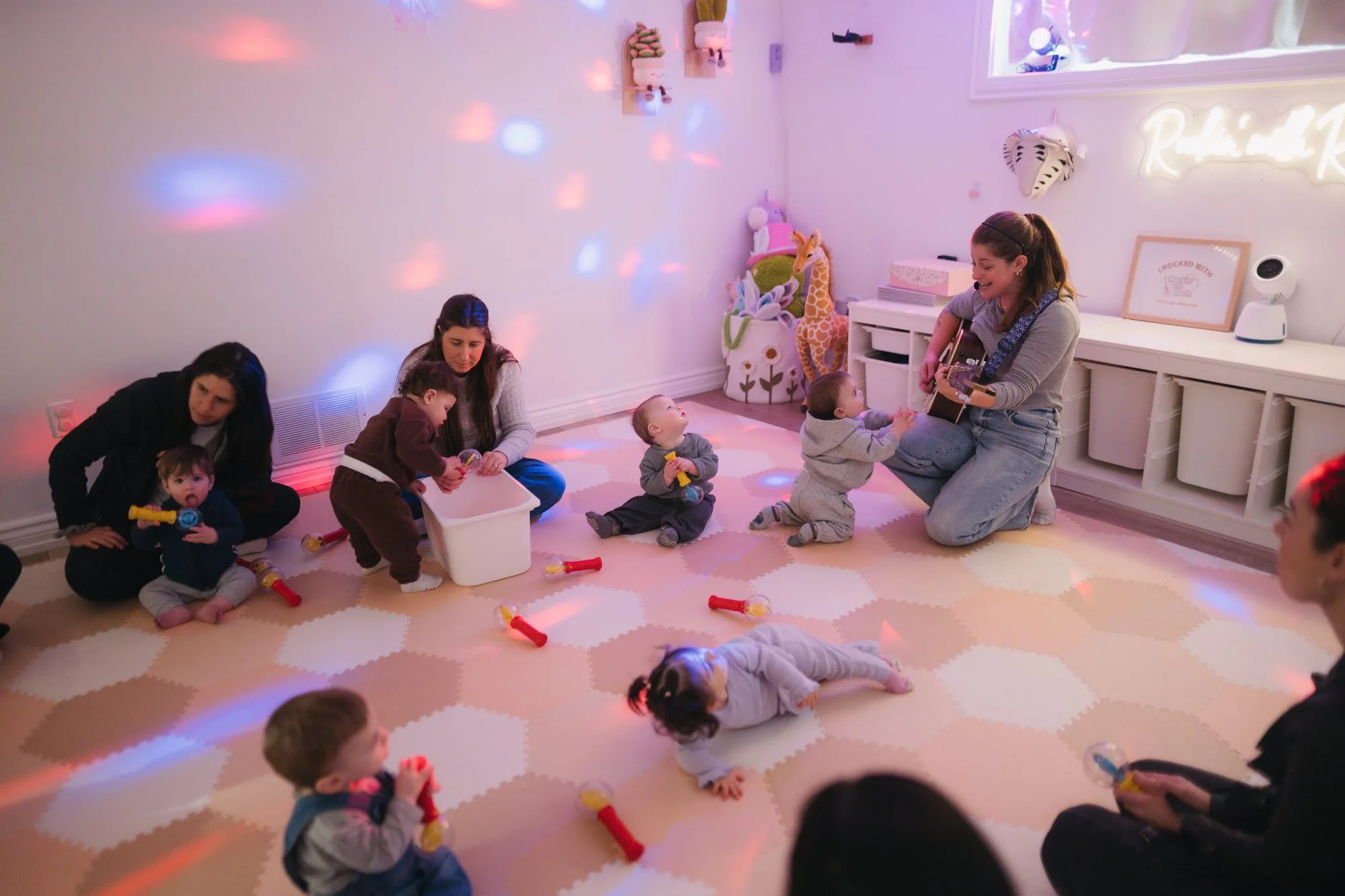 Rockin' with Rach baby music class with light show and neon sign in Toronto studio