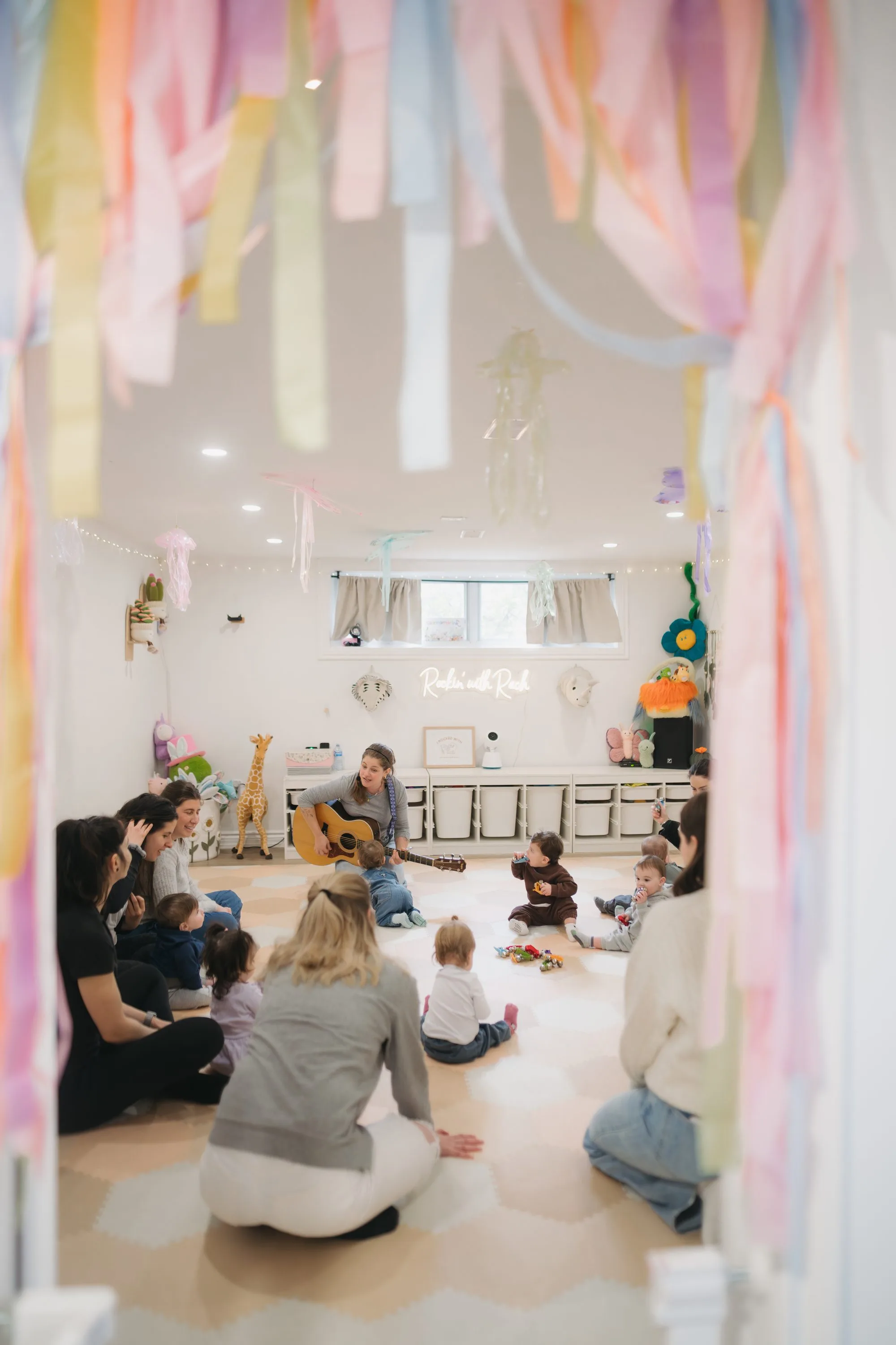 Rockin' with Rach birthday party with pastel streamers and babies in a circle Toronto