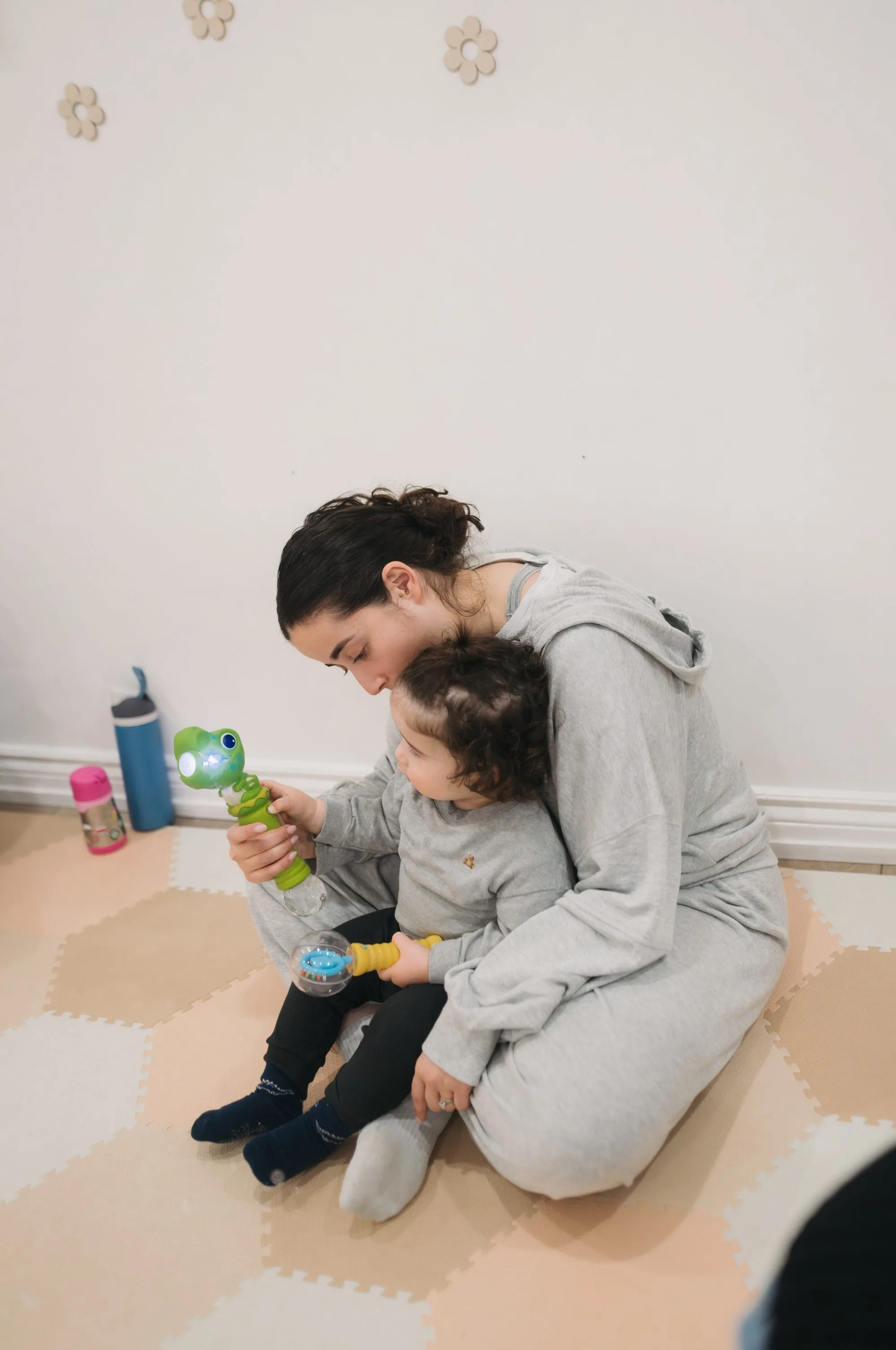 Mom cuddling baby during music class at Rockin' with Rach Toronto