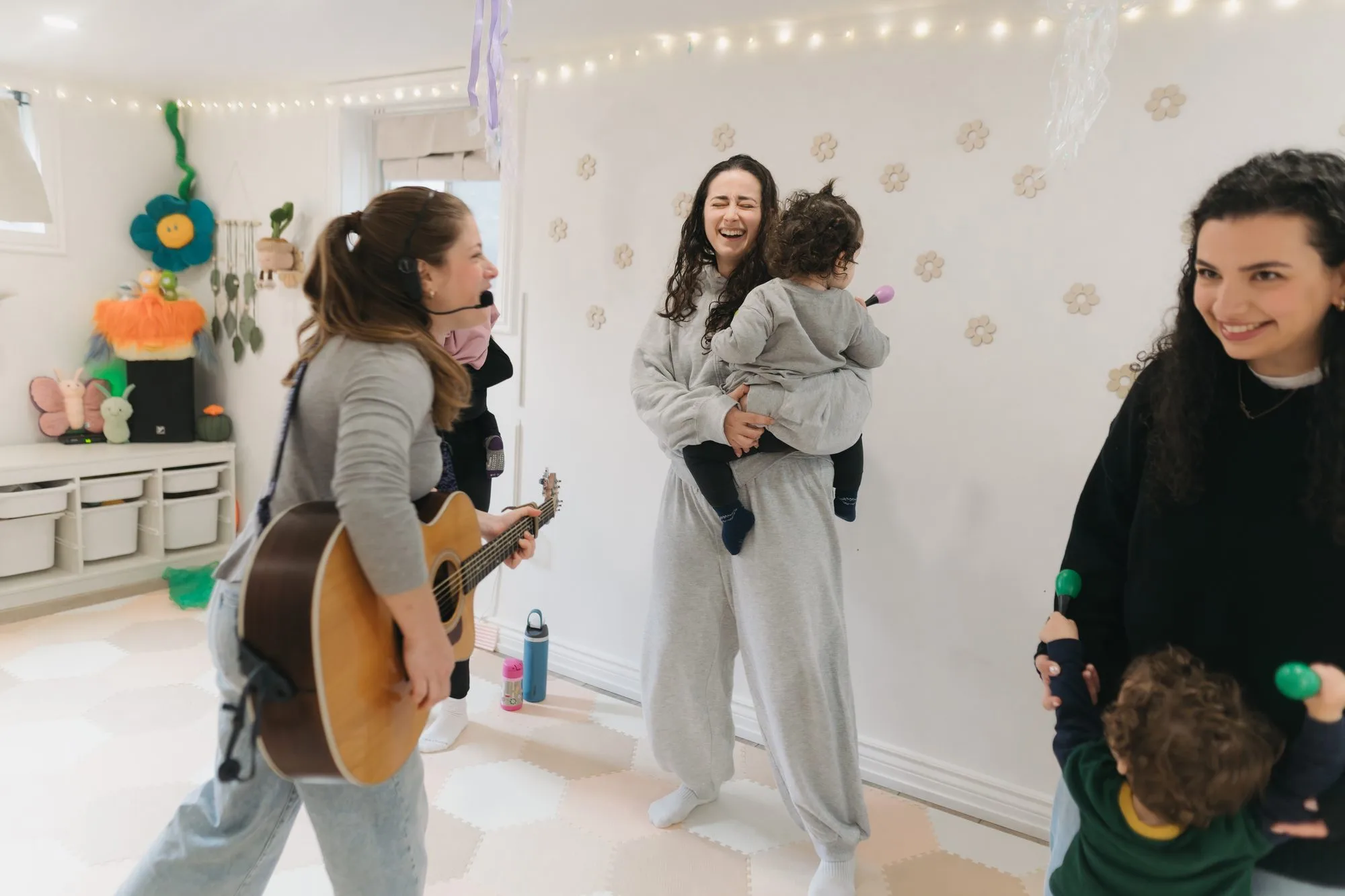 Rachel Kornblum walking through her studio with guitar at Rockin' with Rach Toronto